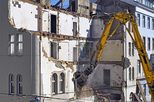 A bulldozer is demolishing an old building construction site in Vienna Austria