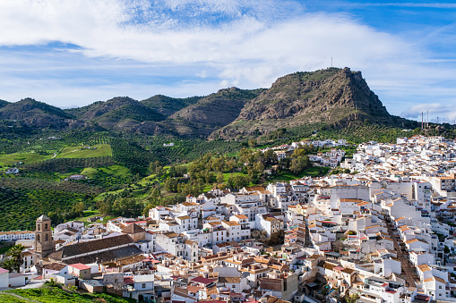 View towards Álora, an Andalusian whitewashed town with the ruins of a castle perched on a rocky spur