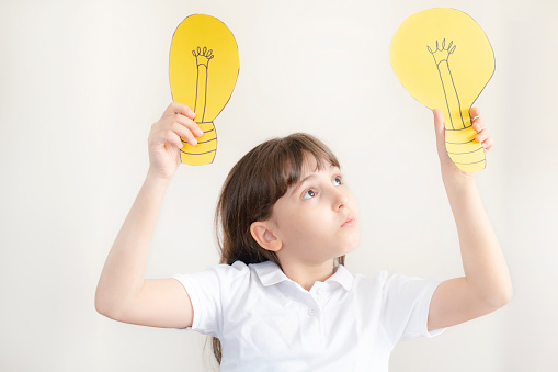 Girl Holding Light Bulb On Head