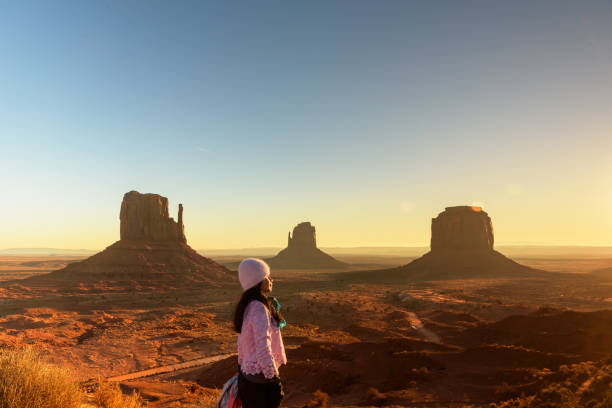 istock Woman watching beautiful sunrise scenery at Monument Valley, Utah 2072787584