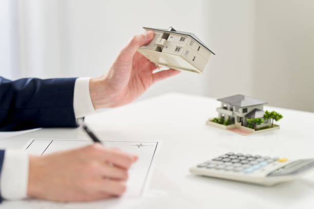 Businessman thinking about real estate floor plan