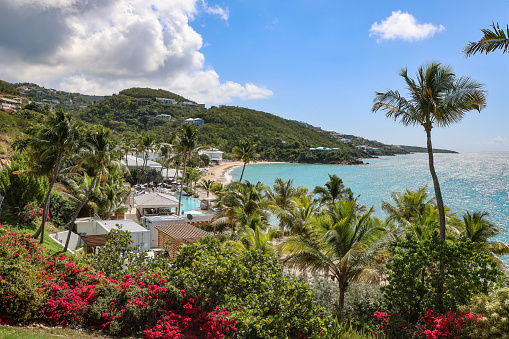 Lush tropical foliage obscures a beachside resort on the island of St. Thomas located in the United States Virgin Islands