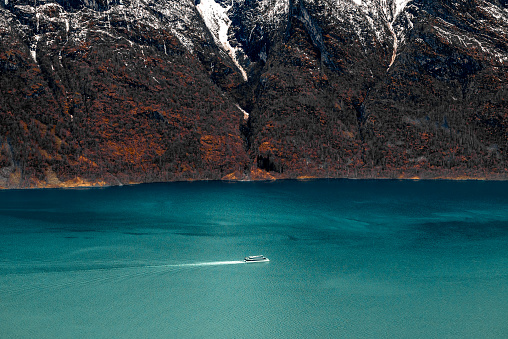 A cruise yacht voyaging through Aurlandsfjord, Norway.