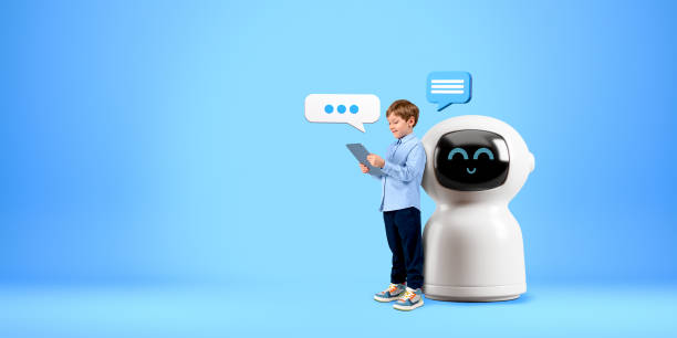 istock Kid with tablet, standing near robot on copy space blue background 2072838514