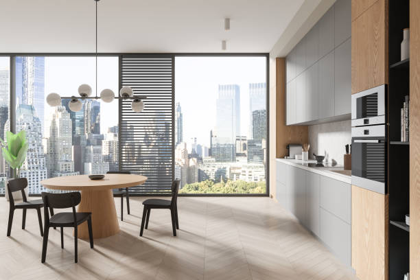 istock Stylish home kitchen interior with cooking and eating table with seats, window 2072852749