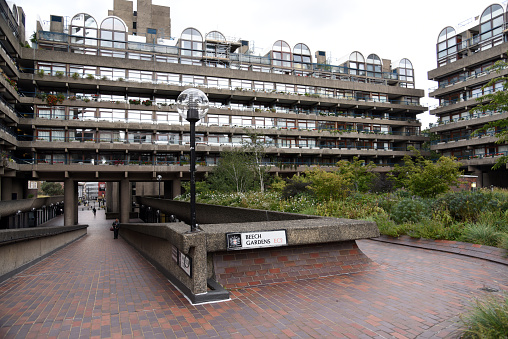 The Barbican Estate, or Barbican, is a residential complex of around 2,000 flats, maisonettes, and houses in central London. The buildings where realized between 1965 and 1976 in brutalist architecture. The image was captured on a cloudy day during summer season.