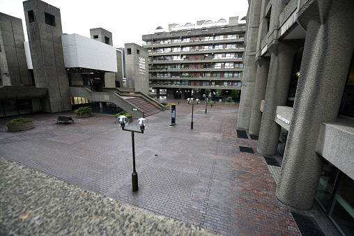 The Barbican Estate, or Barbican, is a residential complex of around 2,000 flats, maisonettes, and houses in central London. The buildings where realized between 1965 and 1976 in brutalist architecture. The image was captured on a cloudy day during summer season.