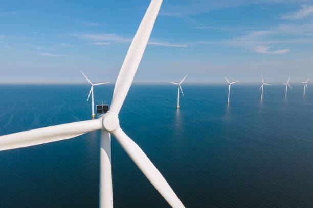 Huge windmill turbines, Offshore Windmill farm in the ocean Westermeerwind park , windmills isolated at sea on a beautiful bright day Netherlands Flevoland Noordoostpolder Offshore Windmill farm in the ocean Westermeerwind park, windmills isolated at sea on a beautiful bright day Netherlands Flevoland Noordoostpolder. Huge windmill turbines offshore wind farm stock pictures, royalty-free photos & images