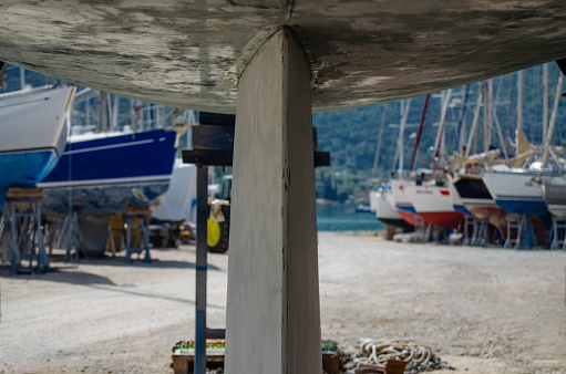Repair of the underwater part of the hull of a sailing yacht in dry dock.