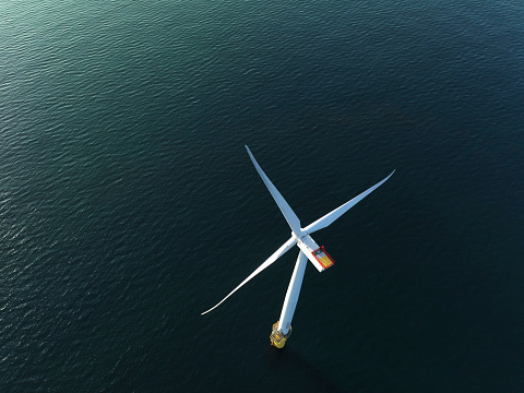 An offshore wind power installation is situated in the sea, consisting of a series of turbines mounted on sturdy platforms. These turbines harness the power of the wind to generate clean and renewable energy. Against the backdrop of the vast ocean, the installation stands as a symbol of sustainable energy production and environmental stewardship.