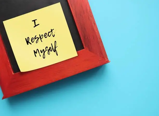 Note stick on photo frame on blue background with text message I RESPECT MYSELF, concept of self-respect, knowing you are worthy, develop self-love with self-acceptance