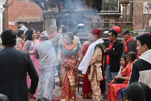 Kirtipur, Nepal - February 12, 2024 - The Newari Wedding symbolizes the beginning of a new chapter in the couple’s lives. Newari weddings are as rich as their culture; rich in rituals, following and honoring their Gods and blissful experience throughout the process. But after the invasion of Gorkhali Shah Dynasty, the Newari community moved from Kathmandu and spread over the entire valley, the traditions have been altered and revised
