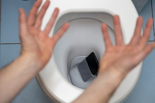 Smartphone Fallen into the Toilet Bowl photo