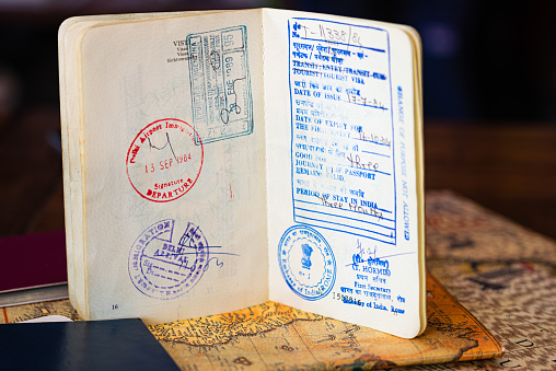Old Indian Visa with arrival and departure dates on a passport. Holidays concept. Horizontal view.