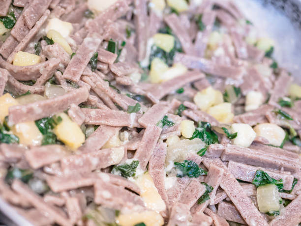 close up of the succulent and typical italian dish pizzoccheri. typical dish from valtellina, lombardy, italy. - pizzoccheri homemade tagliatelle italy imagens e fotografias de stock