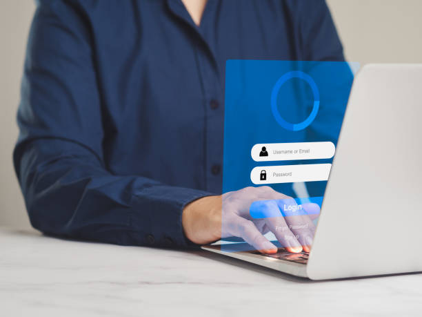 istock Woman using a laptop with a login or password form on a virtual screen. 2072994653