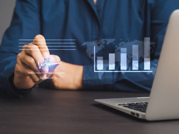 istock Businessman uses a pen to sign electronic documents on a virtual screen while sitting at the desk 2072997246