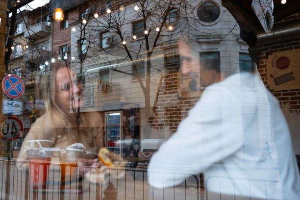 Having coffee together in a local coffee shop.