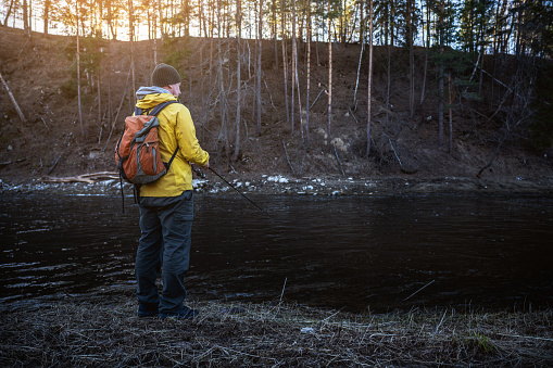 A fly fisherman wades through a river in Nova Scotia.