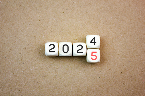 2024,2025 shift on wooden cubes. Annual concept 2024,2025. Plan, goal, trend 2024,2025.