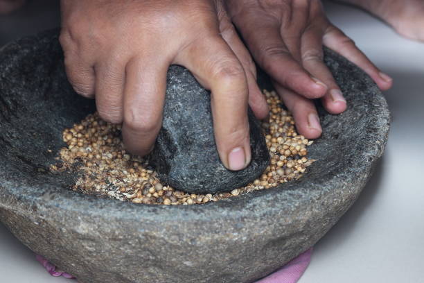 istock Grind the grain spices using a traditional tool from Indonesia 2073081240