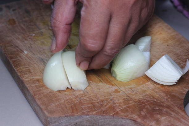 istock Cutting large onions of the same size 2073083803