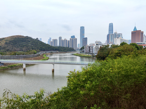 The Sham Chun River, or Shenzhen River which is the natural border between Hong Kong and Mainland China at Luohu-Lowu border. In the distance, Shenzhen skyline.