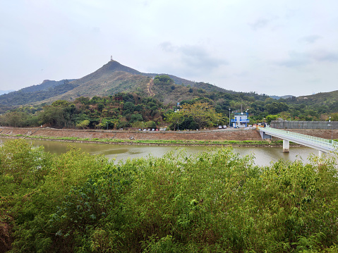 The Sham Chun River, or Shenzhen River which is the natural border between Hong Kong and Mainland China at Luohu-Lowu border. In the distance, the green mountain of Hong Kong New Territories.