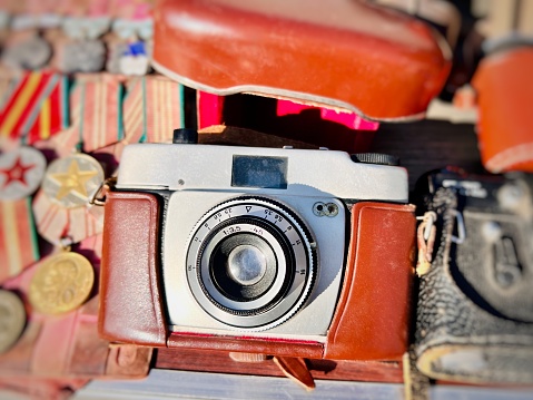 Old camera with film and carrying case sunlight reflected