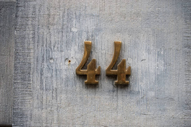 istock metallic number 44 on stoned wall of building 2073138816