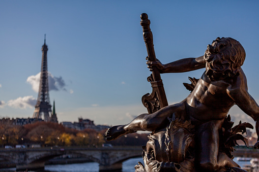 Ornate lamp post on Pont Alexandre III and a dramatic sky