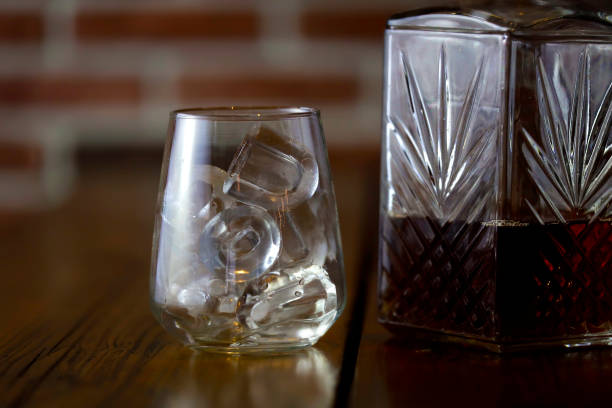 istock Drinking glass with ice and a bottle of alcohol 2073190438