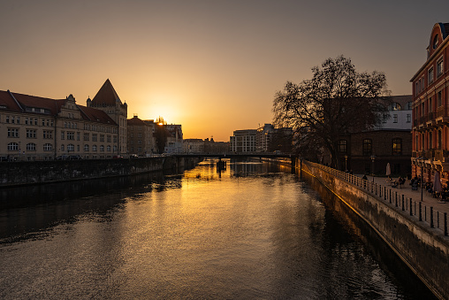 Berlin sunset over the river Spree. View of residential areas with the Berlin cityscape in orange light reflection