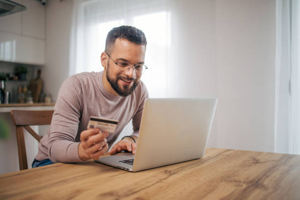 istock Adult man sitting in his modern kitchen. 2073222354