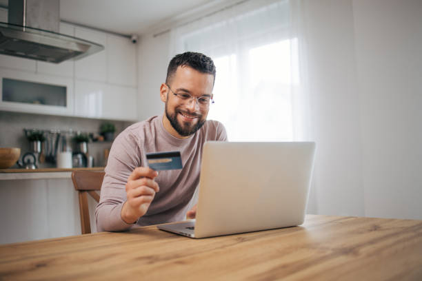istock Adult man sitting in his modern kitchen. 2073223396