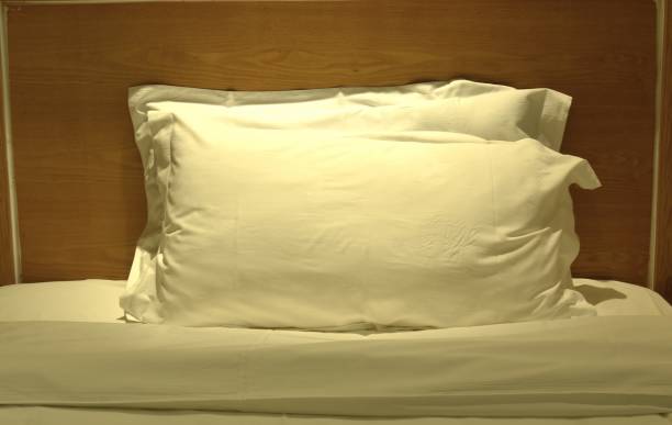 istock two pillow and  blanket opened for one people on single bed 2073228639