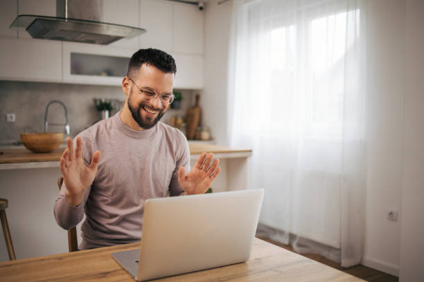 istock An attractive man is talking on a video call. 2073229166