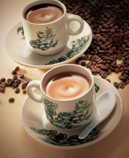 Hainanese coffee and tea in vintage cup surrounding with coffee beans