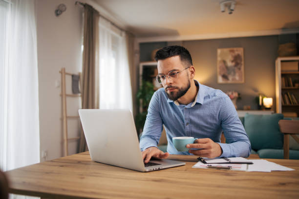 istock adult man work from home online. 2073235573