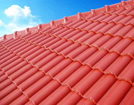 Roof top with ceramic tiles against blue sky