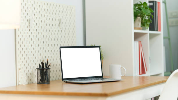 istock Home office desk with computer laptop, coffee cup and houseplant on wood table. 2073240576