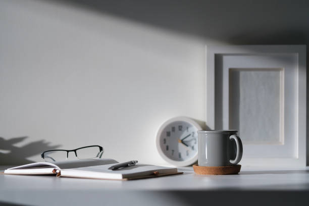 istock Creative workspace with blank poster frame, camera, coffee cup and houseplant on wood table. 2073241152