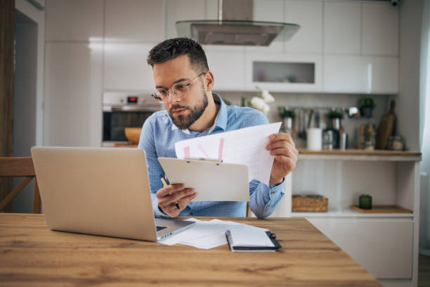 istock Good looking man working at home in his kitchen. 2073242230