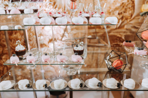 istock Festive dessert table with sweets. Wedding candy bar, various cakes, chocolates on stands. 2073263301