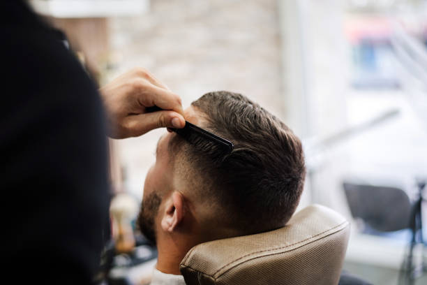 istock Barber shaves the beard of the client 2073288620