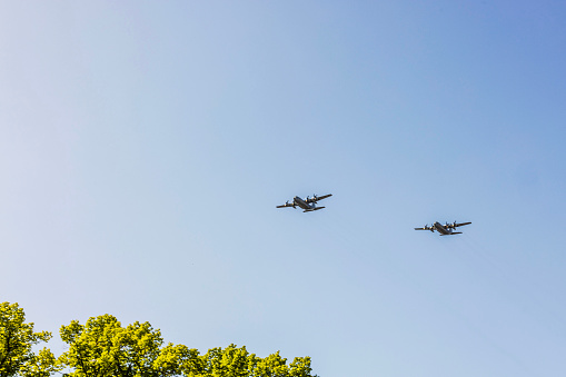 A stunning view of two military aircraft in flight above the treetops. Sweden.