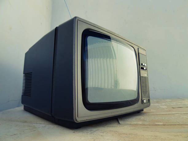 istock a television set on a table by a wall, with its antenna extended, a 2073300108