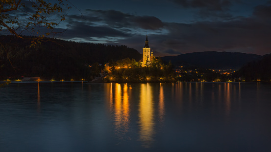 Idyllic Church of the Mother of God on the lake Bled in Slovenia at calm night.