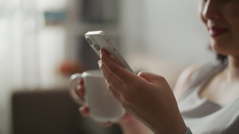 Hand of a woman operating a smartphone