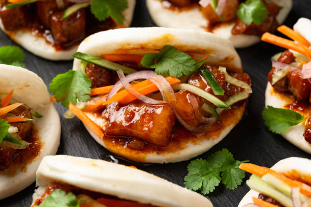 istock Bao buns with pork belly and vegetable. Asian cuisine 2073332638
